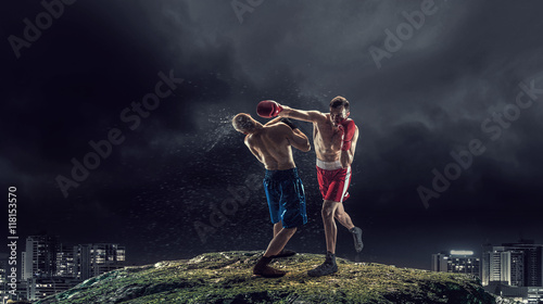 Fototapeta Naklejka Na Ścianę i Meble -  Box fighters trainning outdoor . Mixed media