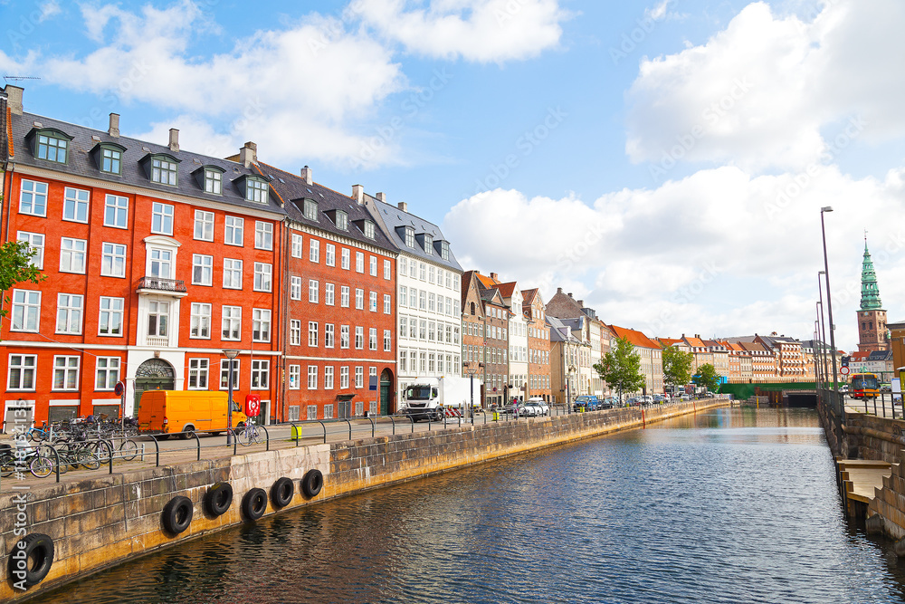 Waterfront city buildings along the canal in Copenhagen, Denmark. European city life during summertime.