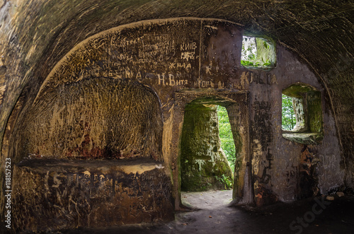 Rooms carved into the rock with doors and windows in the cave monastery in the Carpathian foothills Rozhirche photo