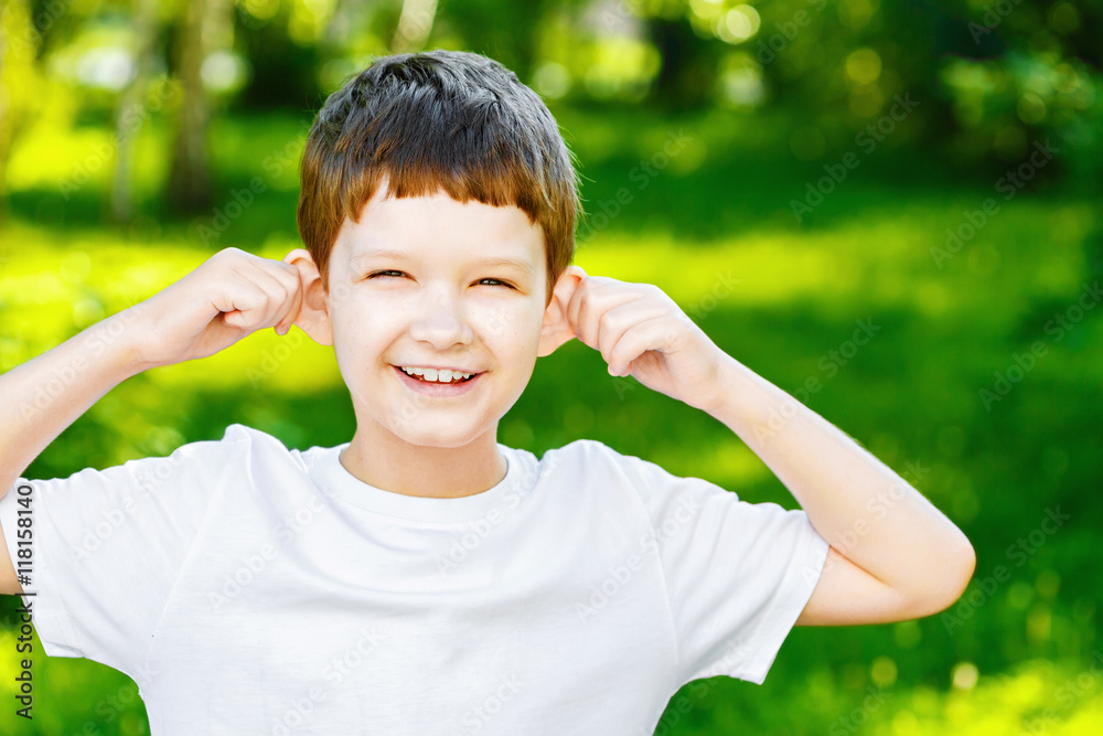 Happy Little boy, pulling himself on the ears Happy Little boy, pulling himself on the ears