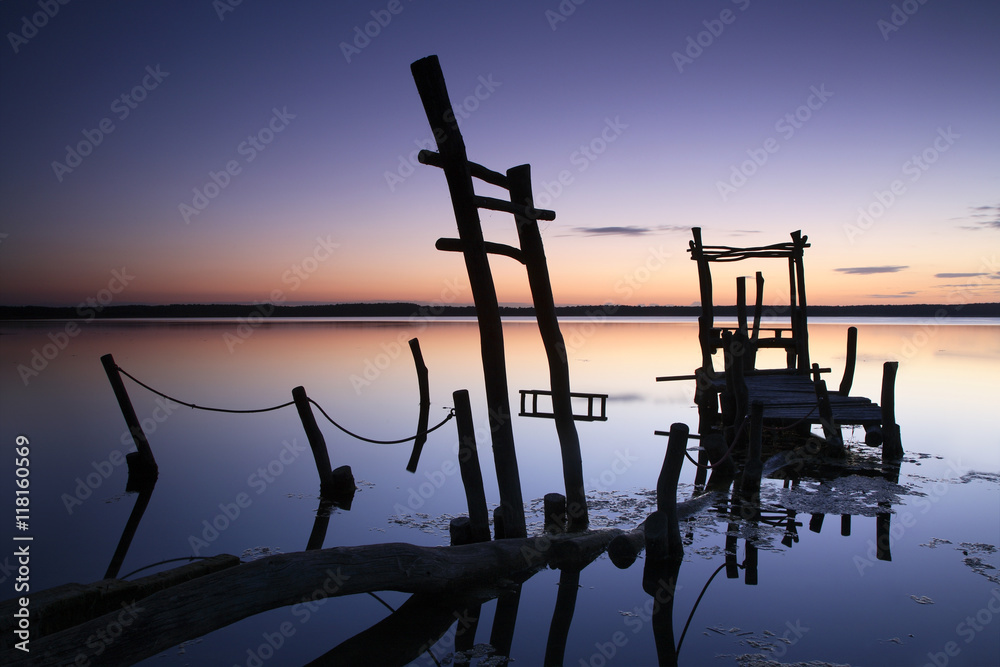 Abandoned Sunken Pier on a Calm Lake at Sunrise