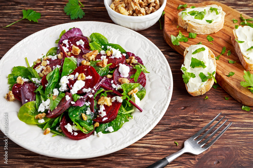 Healthy Beet Salad with fresh sweet baby spinach, kale lettuce, nuts, feta cheese and toast  melted 