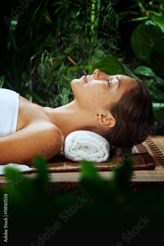 portrait of young beautiful woman relaxing in spa environment