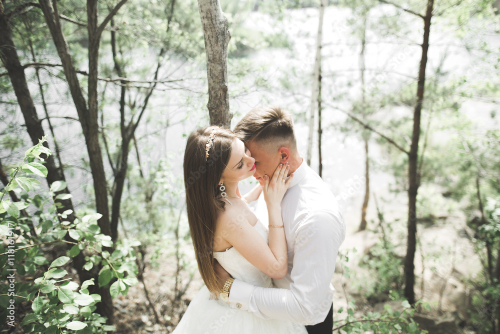 Wedding couple man, bride kissing and hugging on a background of the river, mountains. Beauty portrait Wedding couple man, bride kissing and hugging on a background of the river, mountains. Beauty portrait