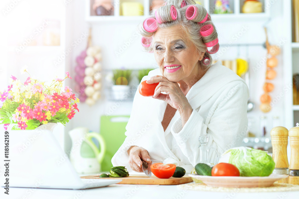 Senior woman in hair rollers at kitchen Senior woman in hair rollers at kitchen