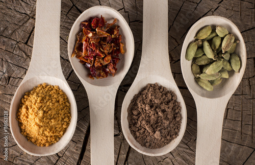 Fototapeta Naklejka Na Ścianę i Meble -  deep wooden spoons on table with spices for food: dried red pepp