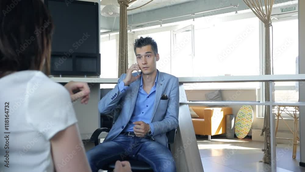 Business man is calling cellphone in front of employee. Business man is calling cellphone in front of employee.