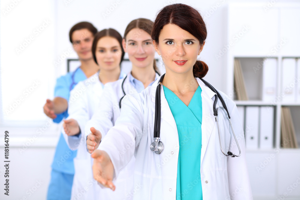 Group of doctors at hospital, focused at female physician. Succesful medical team is ready for helping. Group of doctors at hospital, focused at female physician. Succesful medical team is ready for helping.