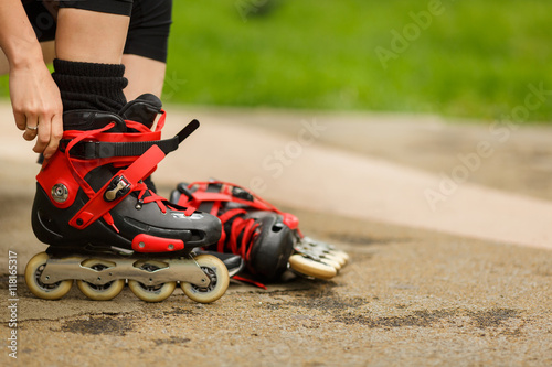 Girl getting ready to ride and wearing red roller blades