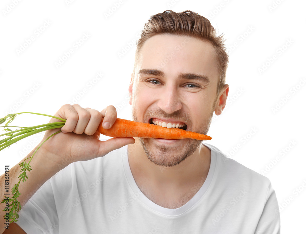 Handsome man eating carrot, isolated on white Handsome man eating carrot, isolated on white