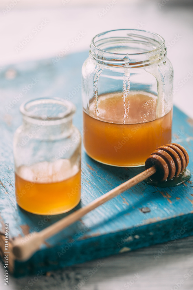Honey in a pot or jar on kitchen table Honey in a pot or jar on kitchen table