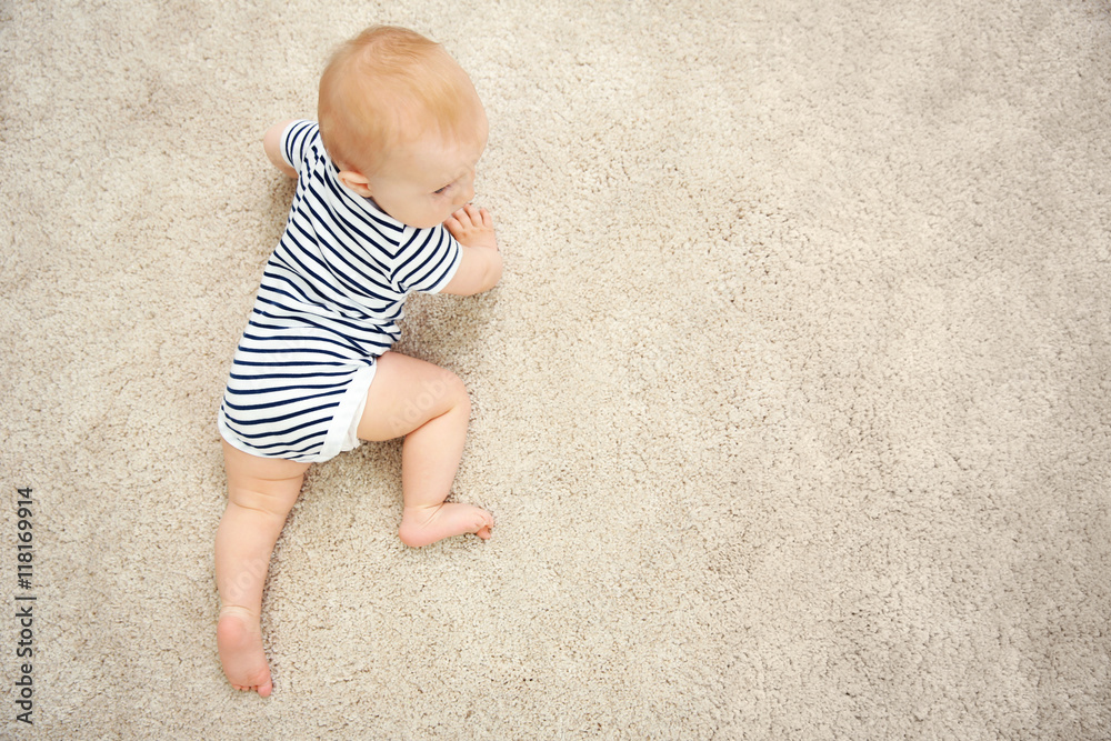 Adorable little baby crawling on light carpet Adorable little baby crawling on light carpet