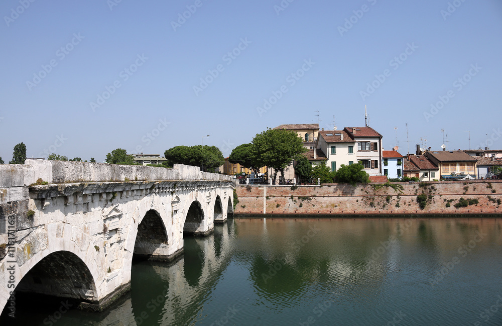 Tiberius bridge and old buildings Rimini Italy