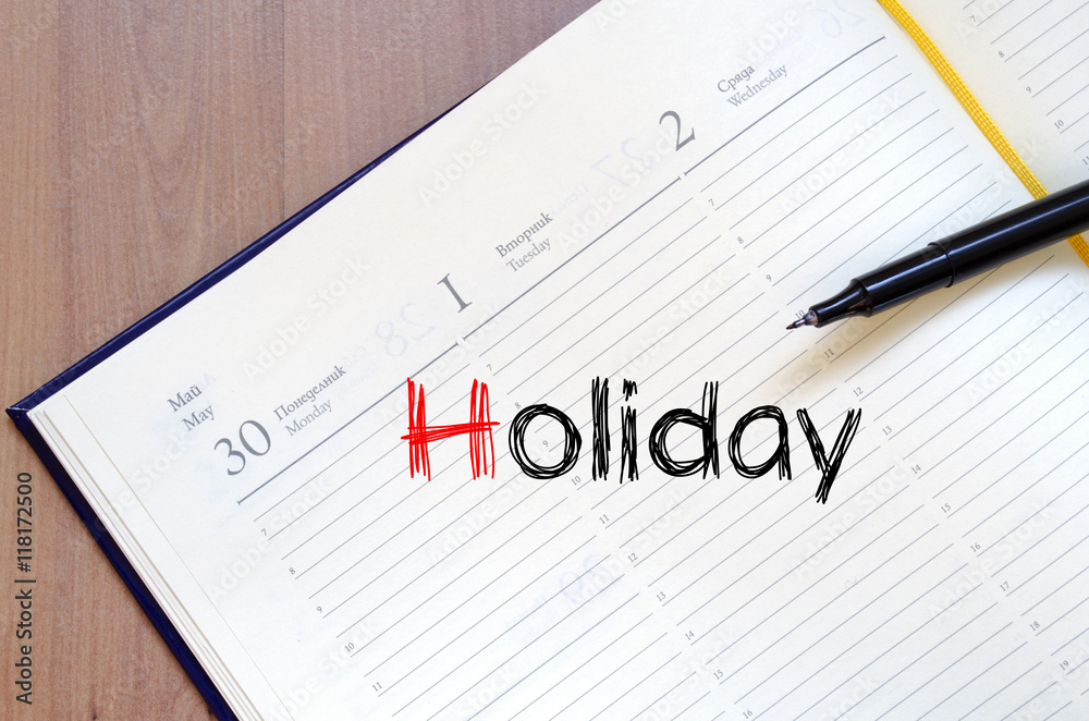 Holiday text concept on notebook Holiday text concept on notebook