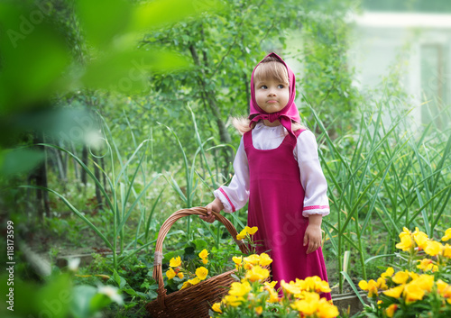Small village girl in folk costume with a basket