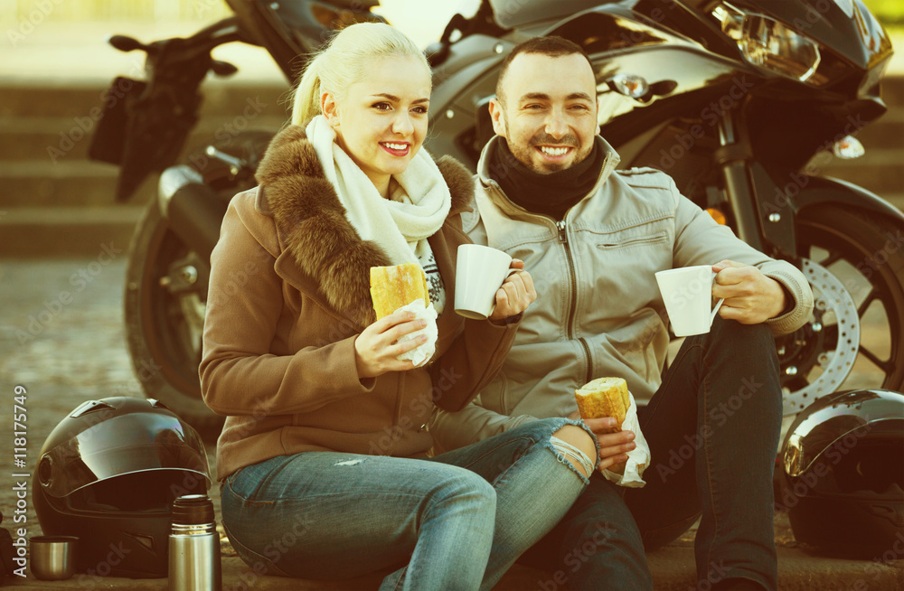 Cheerful  smiling couple having picnic with coffee