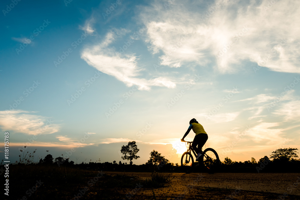 Silhouette of cyclist motion on sunset background Silhouette of cyclist motion on sunset background