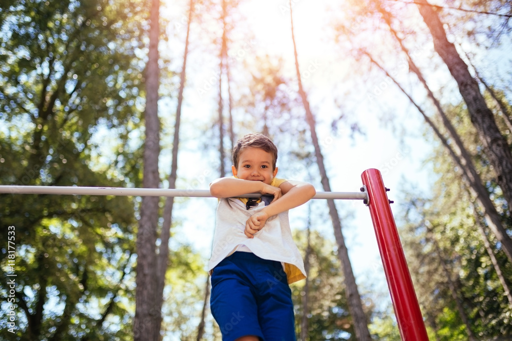 Fototapeta premium Cute little boy playing in a park.