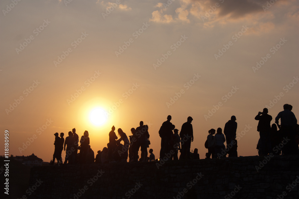 silhouette of people on a sunset background