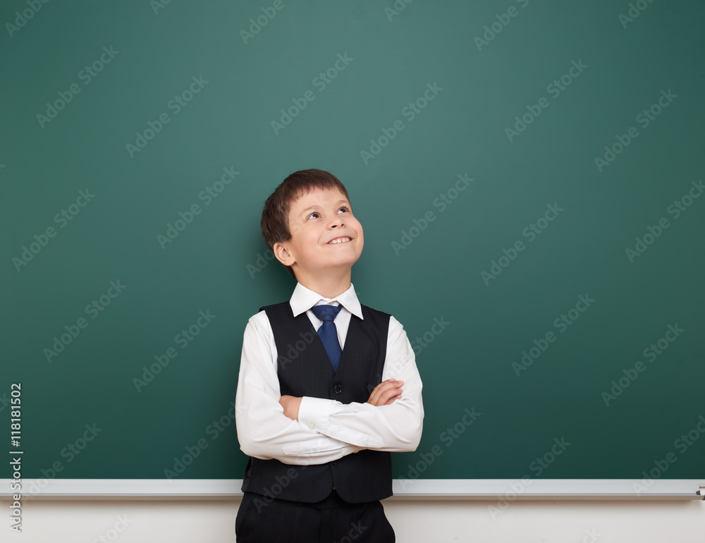 school student boy look up at the clean blackboard, grimacing and emotions, dressed in a black suit, education concept, studio photo school student boy look up at the clean blackboard, grimacing and emotions, dressed in a black suit, education concept, studio photo