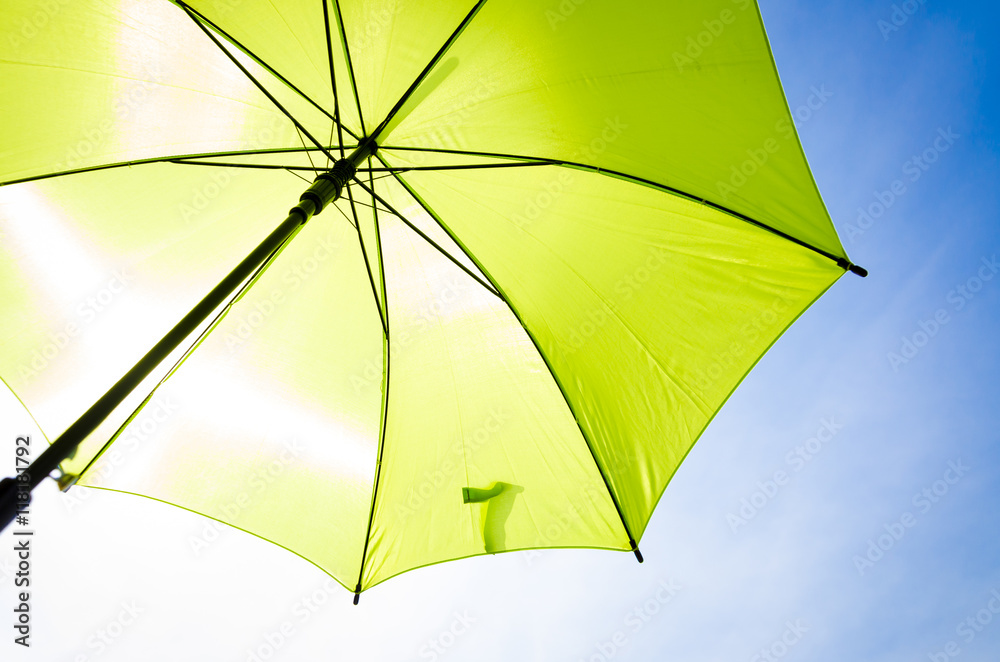 Green umbrella and blue sky