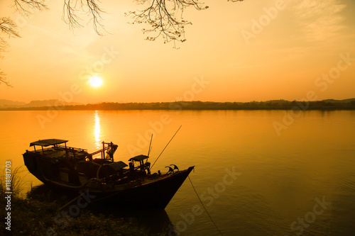 Fishing boat in river in sunset sky, Myanmar.