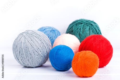 multi-colored balls of yarn for knitting on a white background