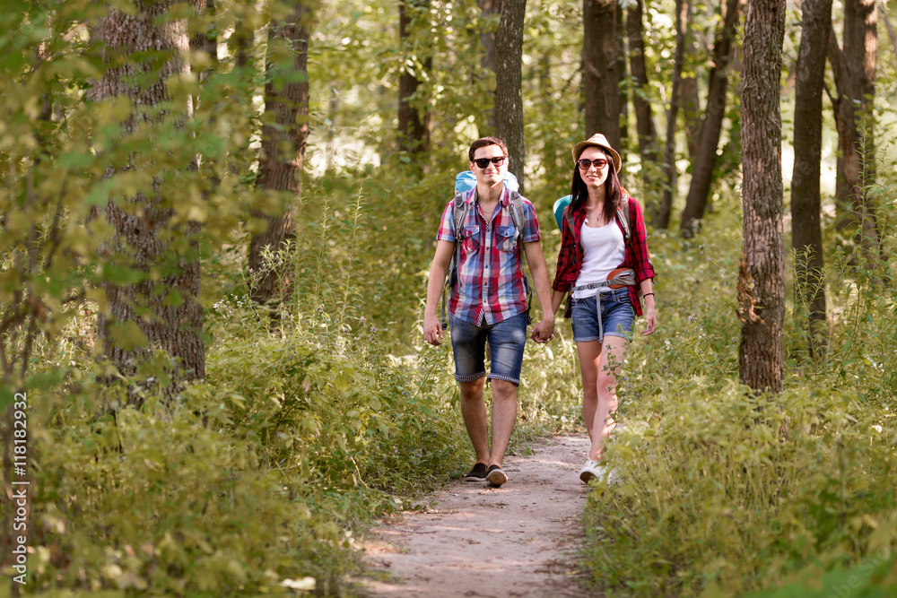Fototapeta premium Young Boy and Girl enjoying Walk in Summer Forest