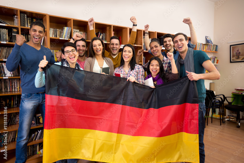 Students with hands raised and smiling faces present German coun - obrazy, fototapety, plakaty 
