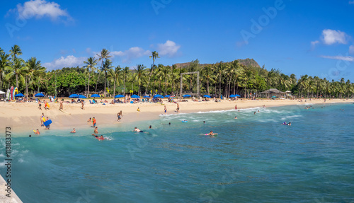 Sun lovers on Waikiki beach in Honolulu  Usa. Waikiki beach is neighborhood of Honolulu  best known for white sand and surfing.