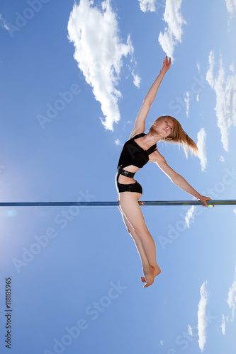 dancer blonde on pole against blue sky