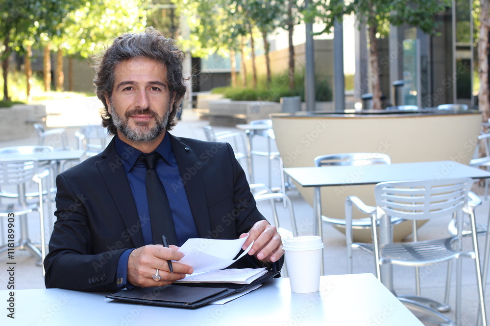 Mature businessman working on outdoors office space Mature businessman working on outdoors office space