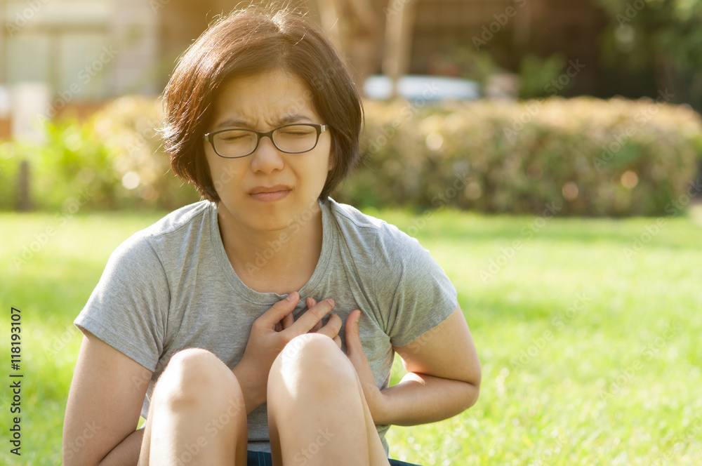 Asian glasses woman having heart attack. Asian glasses woman having heart attack.