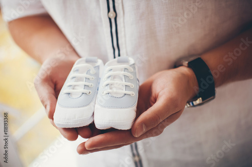 little white shoes for boys in beautiful male hands