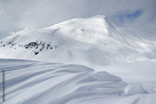 ski resort landscape, waves of fresh snow and slopes tracks