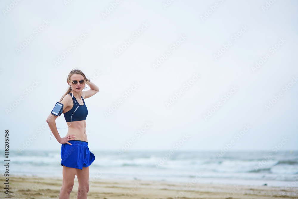 Young fitness running woman jogging on beach Young fitness running woman jogging on beach