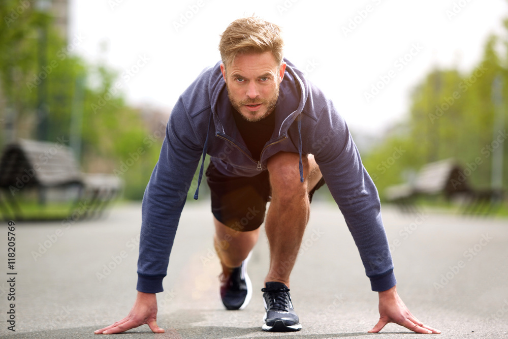 Healthy runner in starting position outside Healthy runner in starting position outside