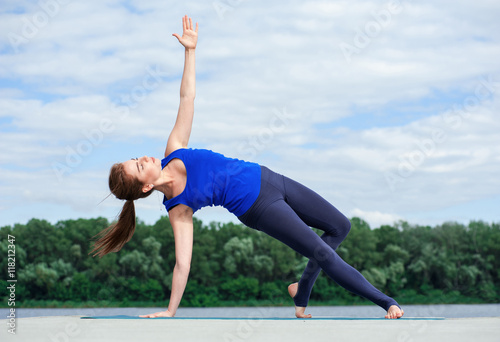 Young woman doing yoga exercise on mat01