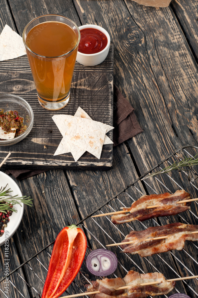 Bacon cooked on the grill with glass of lager Bacon cooked on the grill with glass of lager