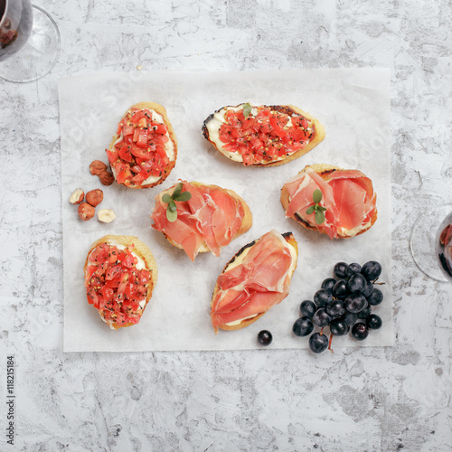 Different appetizers for wine on white paper