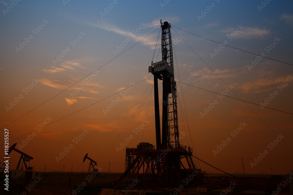 Oil drilling rig in the evening