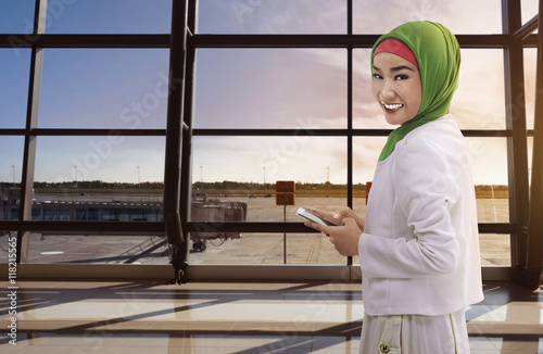 Wallpaper Mural Asian woman muslim holding the phone Torontodigital.ca