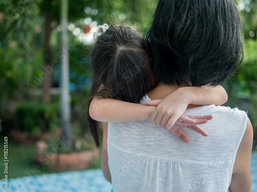 Asian baby girl hugging her mother , sleepy, selective focus a