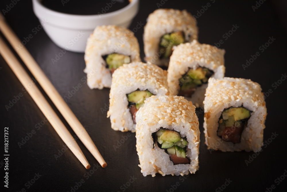 California rolls with avocado, salmon and sesame seeds. horizontal
California rolls with avocado, salmon and sesame seeds. horizontal