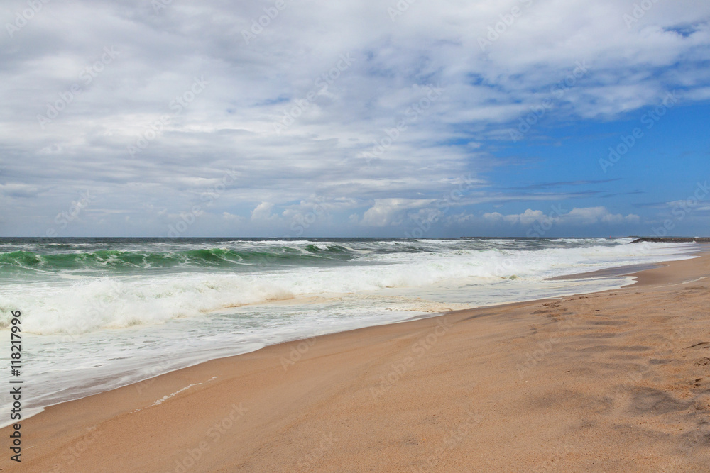 Wonderful sandy beach with slightly waves of Atlantic ocean, Portugal