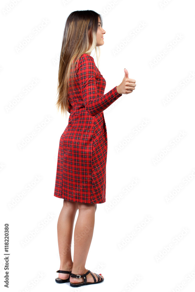 Back view of woman thumbs up. Rear view people collection. backside view of person. Isolated over white background. The girl in red plaid dress standing cancer and shows thumb up. Back view of woman thumbs up. Rear view people collection. backside view of person. Isolated over white background. The girl in red plaid dress standing cancer and shows thumb up.