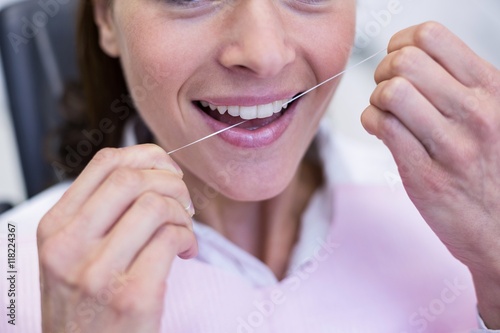 Female patient flossing her teeth