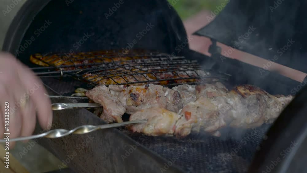 Grilling of barbecue meat on a grill pan with the smoke coming out of the grill pan