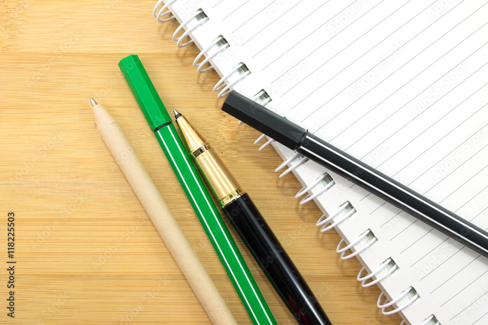 stationery and paper notebook on wooden background stationery and paper notebook on wooden background