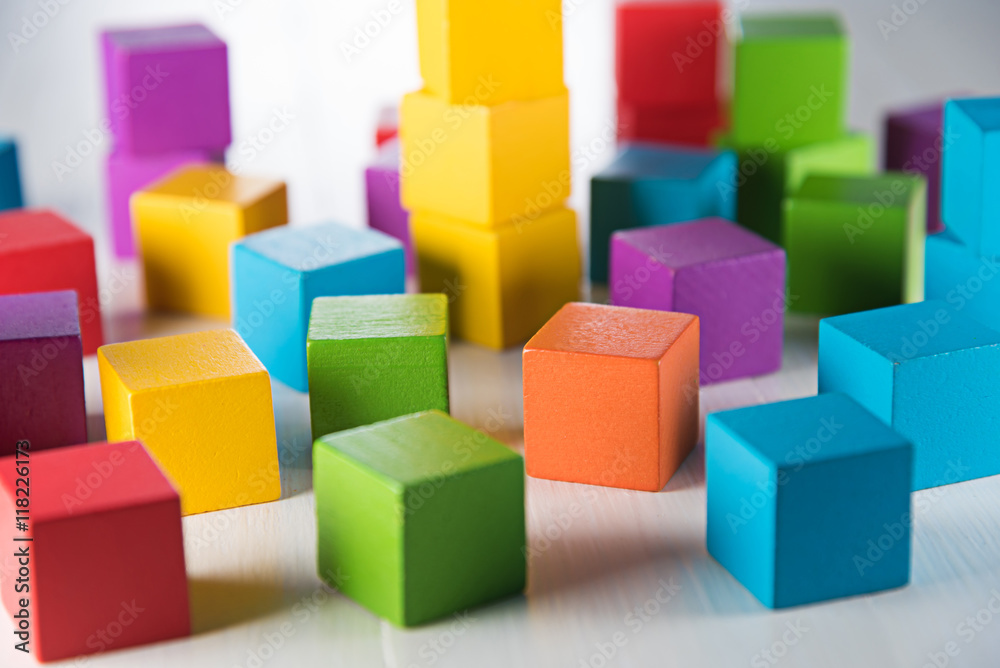 Colorful wood cube building blocks on white wood floor Colorful wood cube building blocks on white wood floor